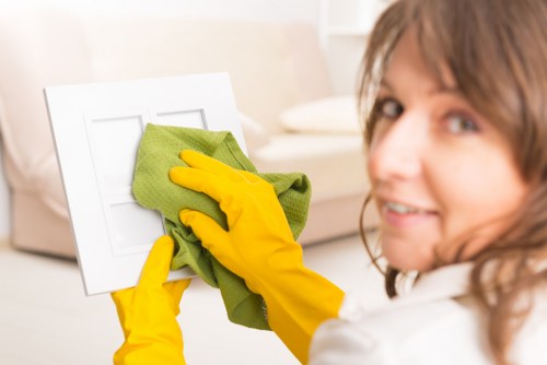 Cleaner in W12 using PPE during a professional cleaning task